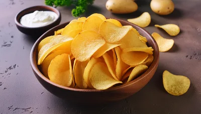 Bowl Of Crispy Potato Chips With Sour Cream Dip