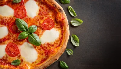Fresh Margherita Pizza With Basil Leaves On Dark Background