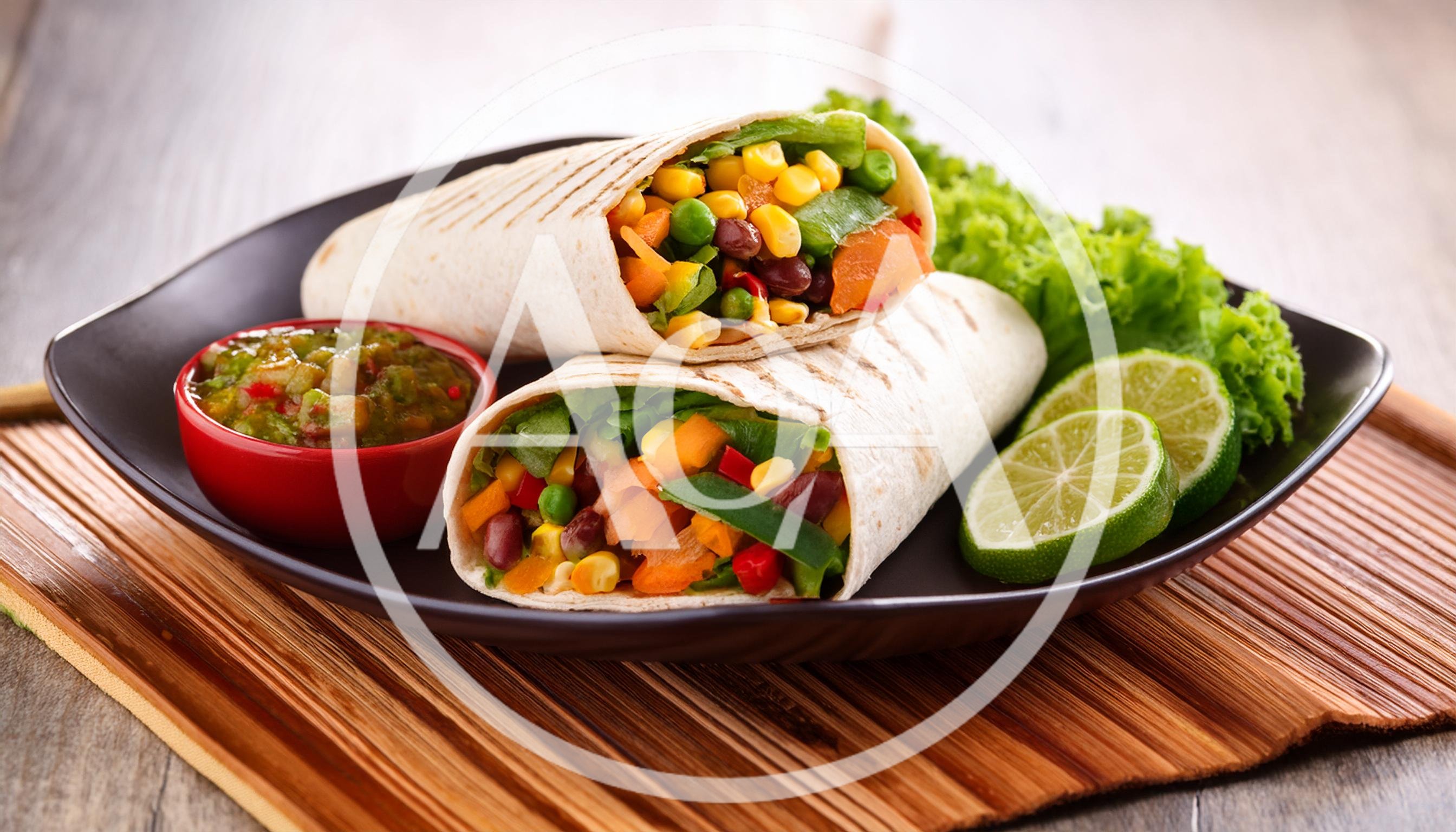 Two Fresh Vegetable Burritos Served With Salsa And Lime