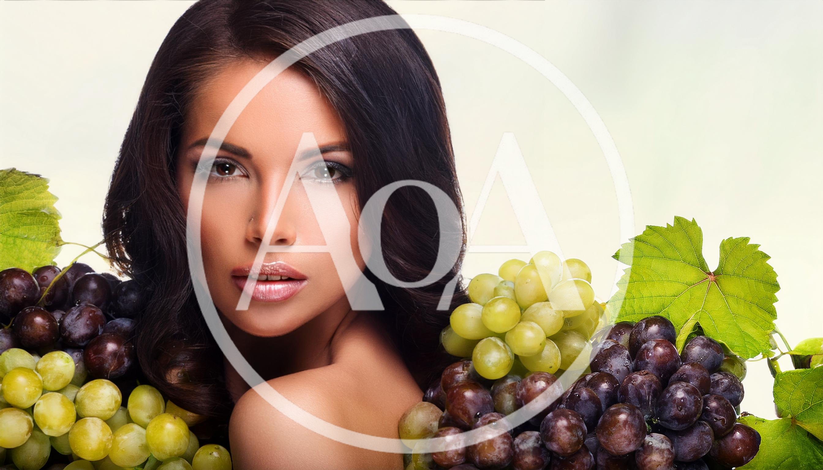 Beautiful Woman Posing With Fresh Green And Purple Grapes