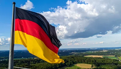 German Flag Waving Over A Scenic Rural Landscape