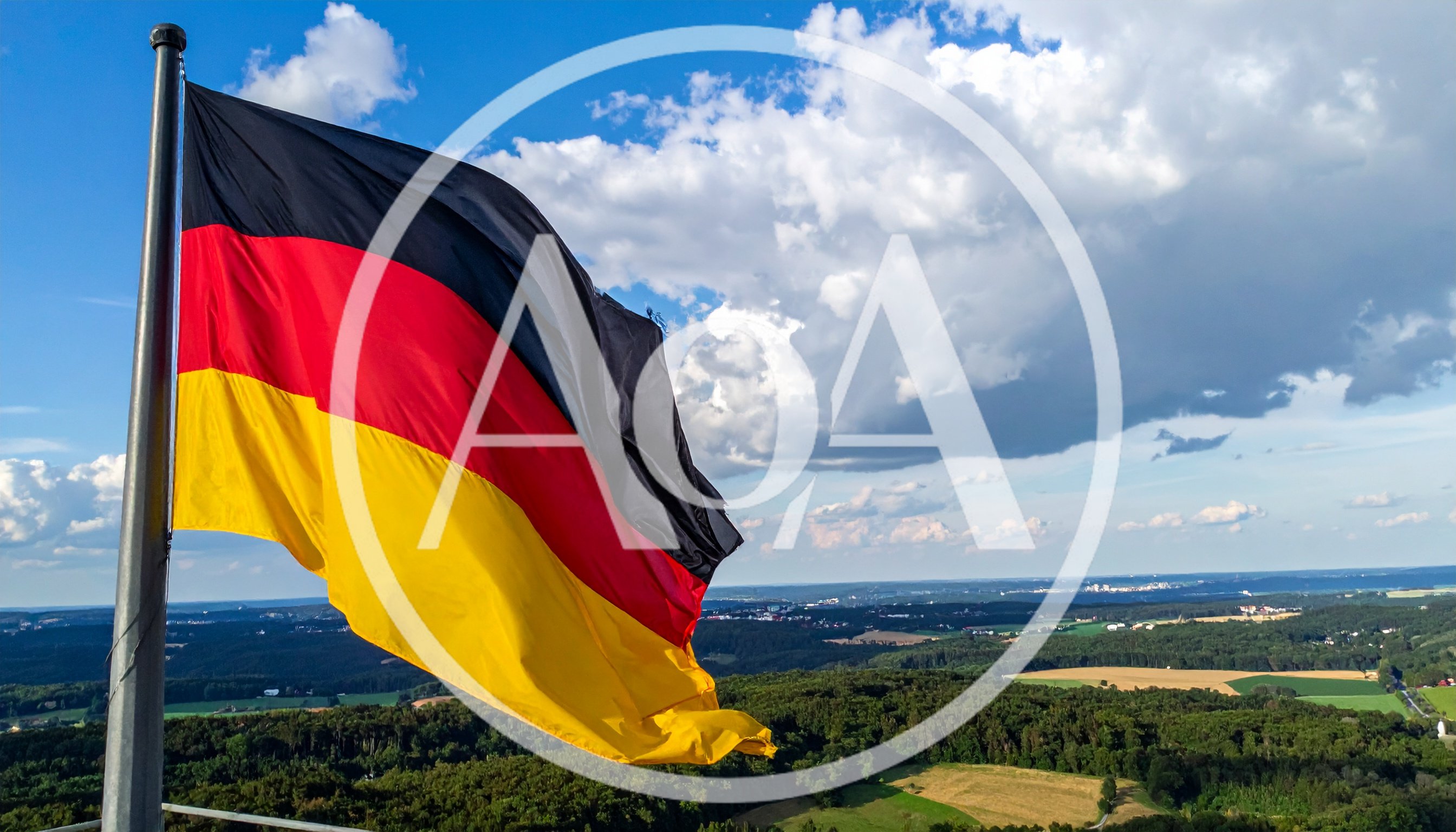 German Flag Waving Over A Scenic Rural Landscape