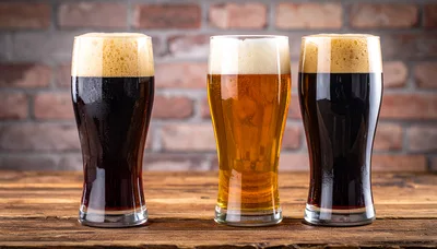 Three Glasses Of Beer On A Wooden Table