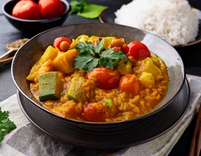 Bowl Of Vegetable Curry With Rice And Tomatoes