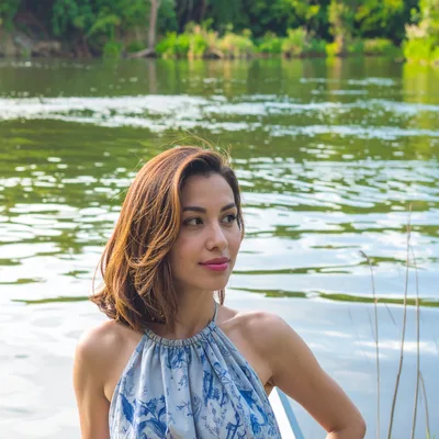 Young Woman Posing Near A Calm River