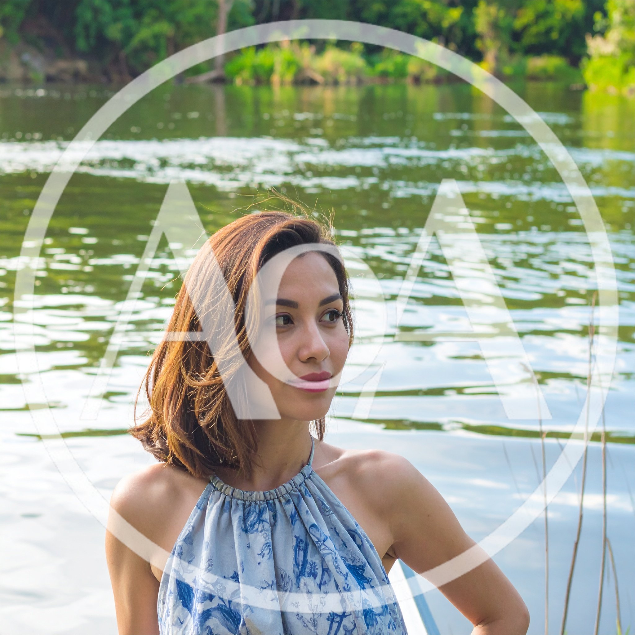 Young Woman Posing Near A Calm River