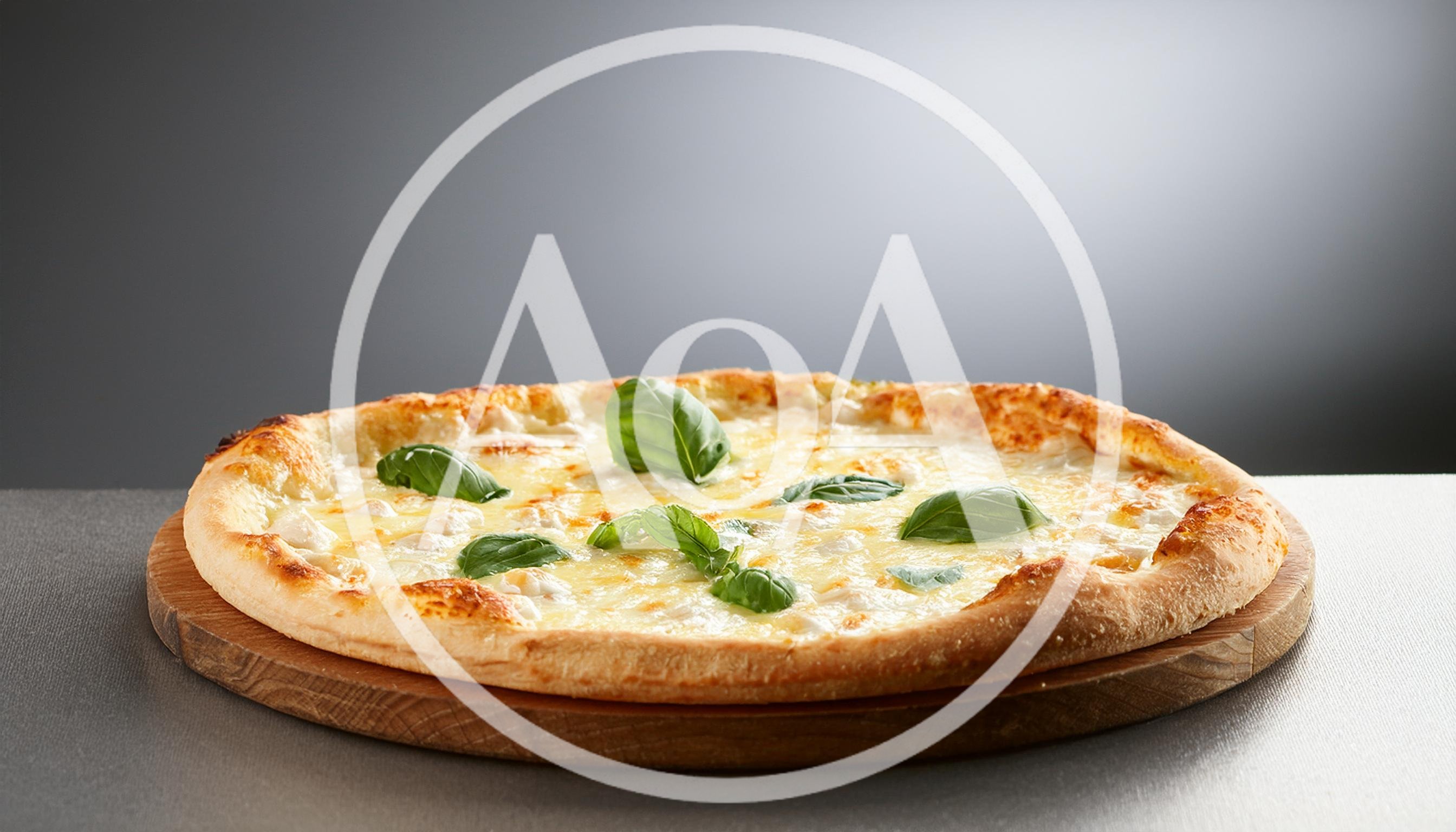 Freshly Baked Four Cheese Pizza With Basil Leaves