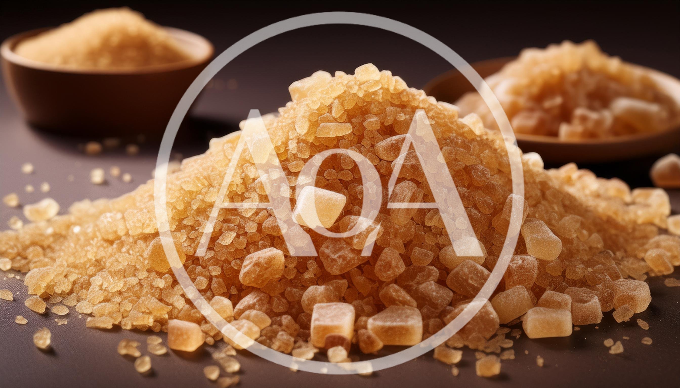 Pile Of Brown Sugar Crystals On Dark Surface