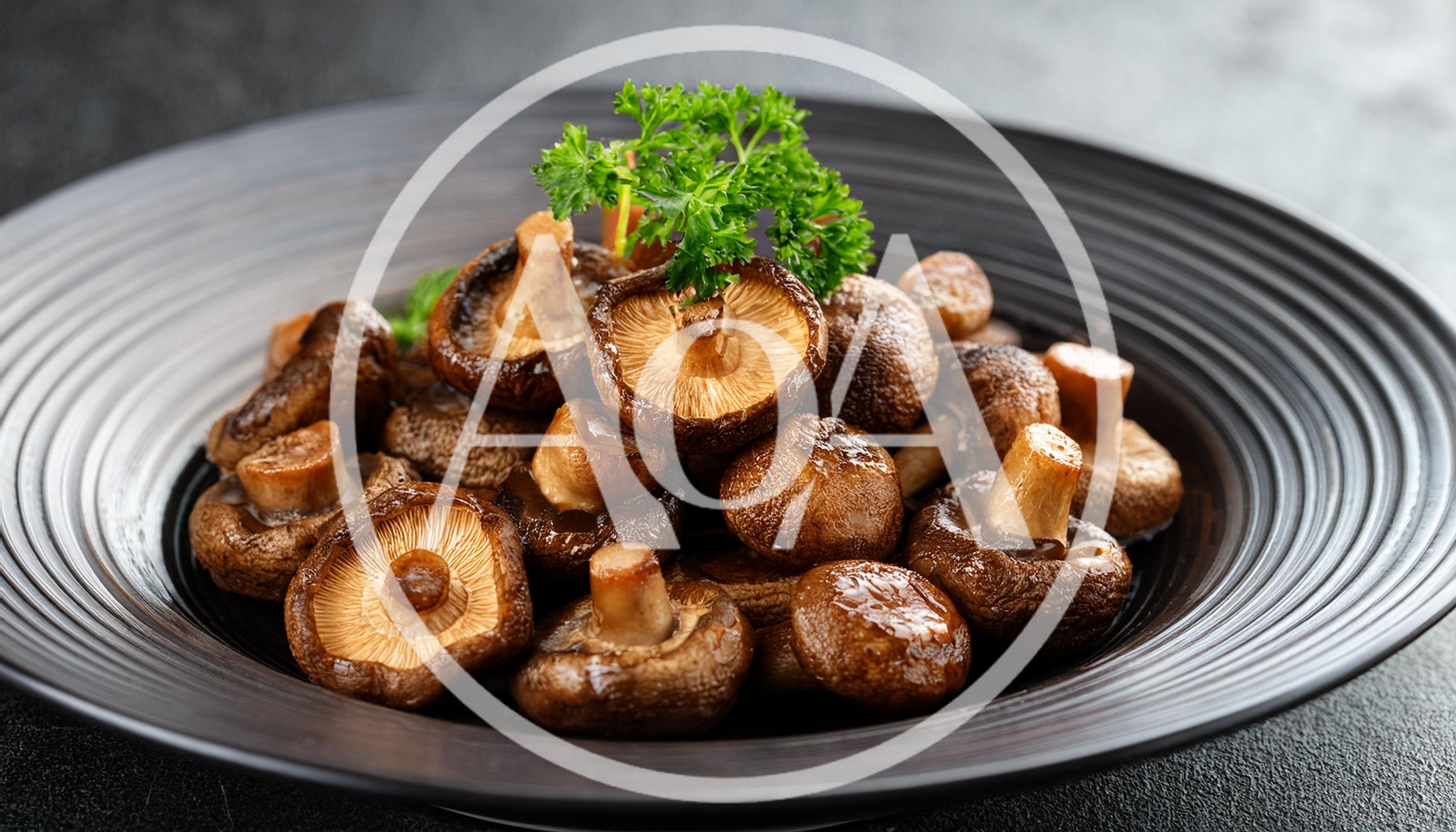 Braised Shiitake Mushrooms Served On A Black Plate