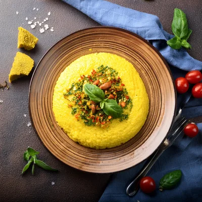 Polenta With Pesto And Pine Nuts On A Plate