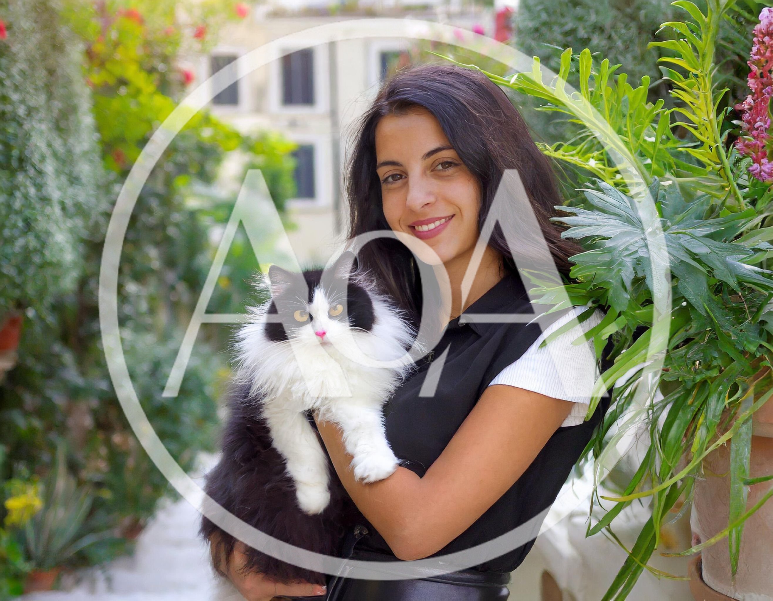Young Woman Holding Fluffy Black and White Cat