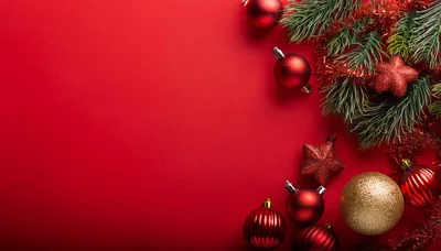 Christmas Ornaments and Pine Branches on Red Background