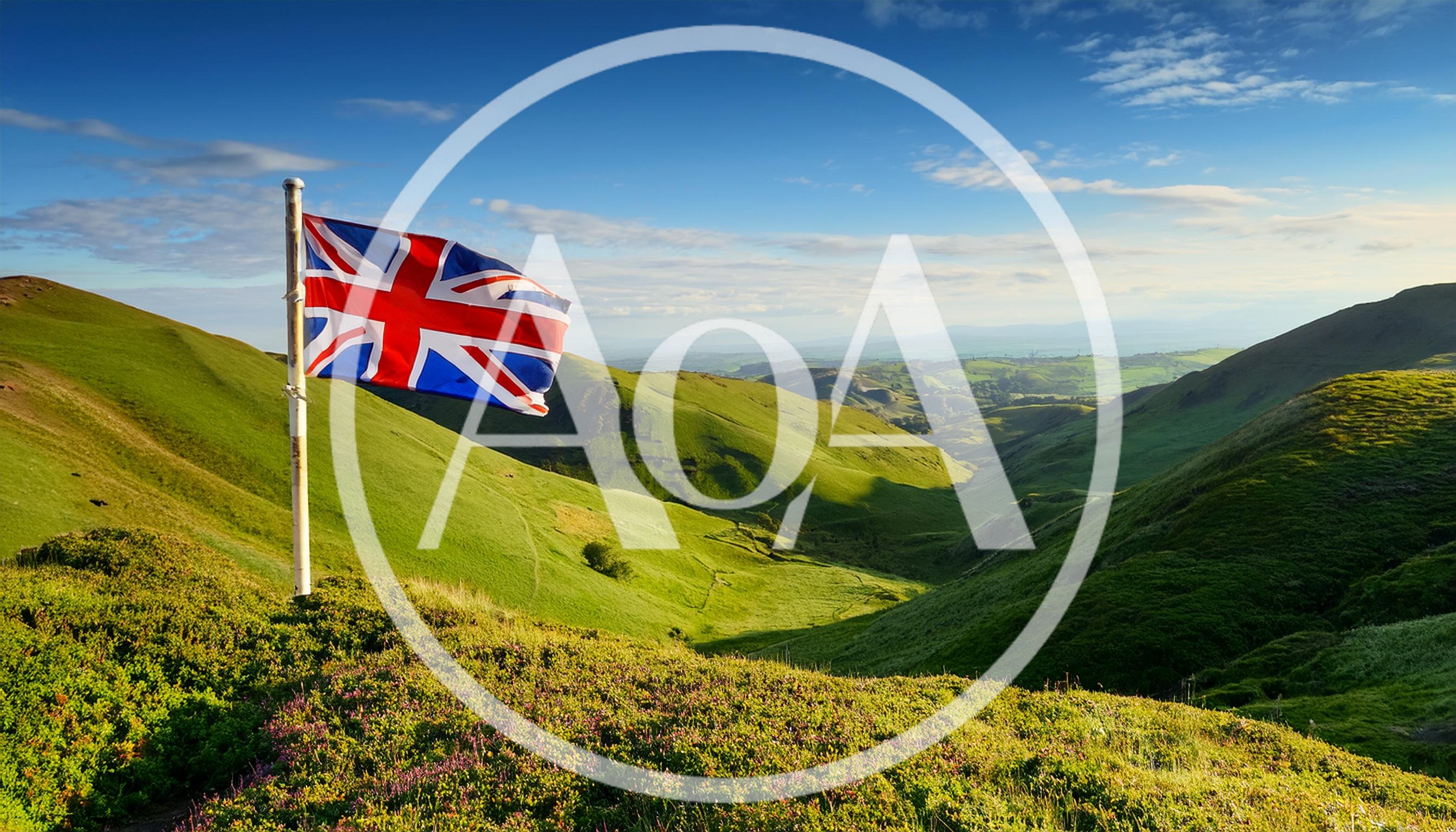 Union Jack Flag Flying Over Rolling Green Hills