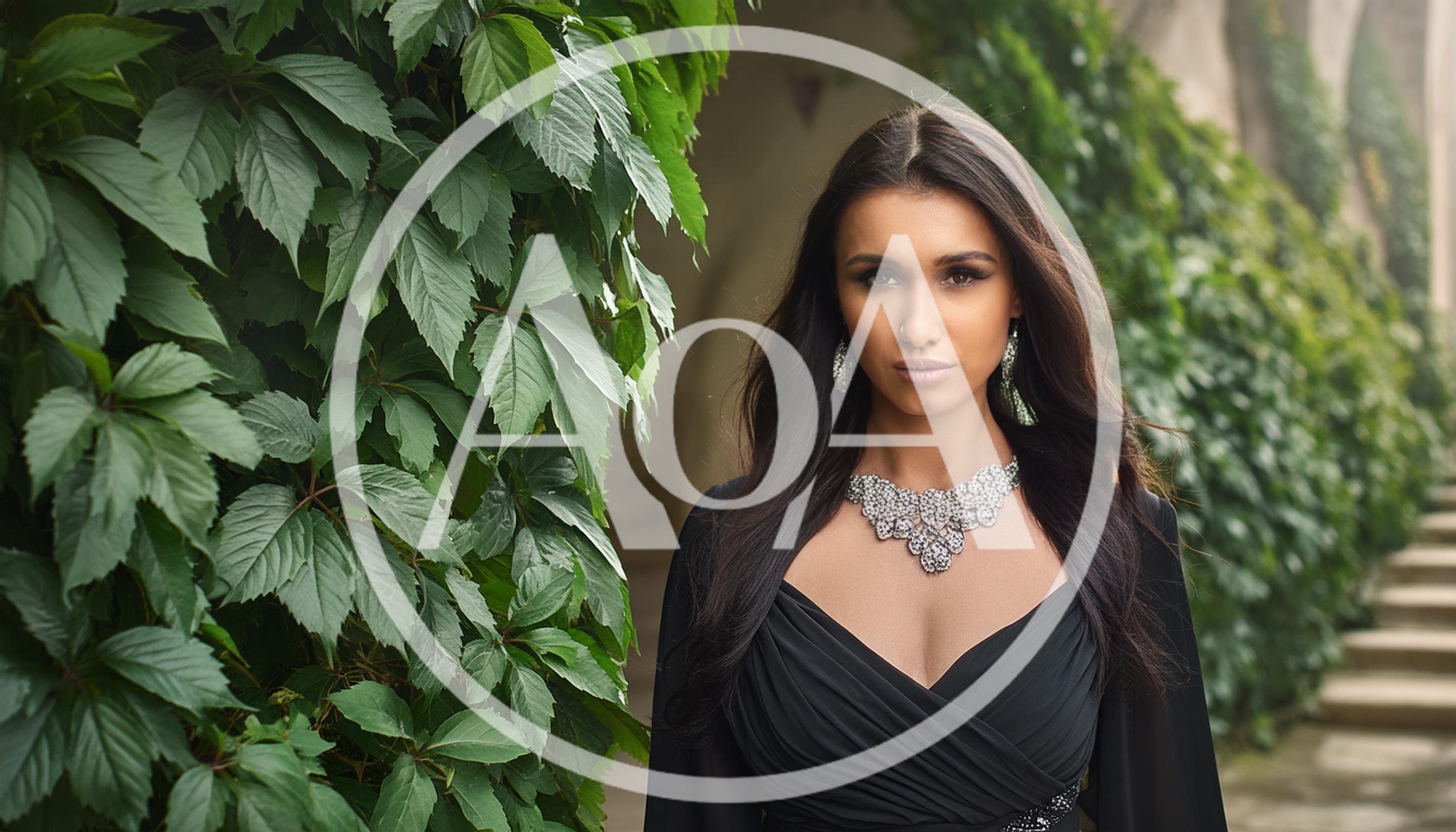Elegant Woman Wearing Diamond Jewelry Near Ivy Wall