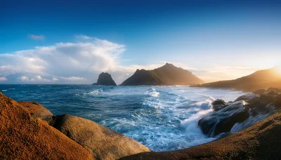 Dramatic Coastal Landscape With Crashing Waves And Mountains