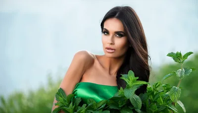 Beautiful Woman Posing With Fresh Green Mint Leaves