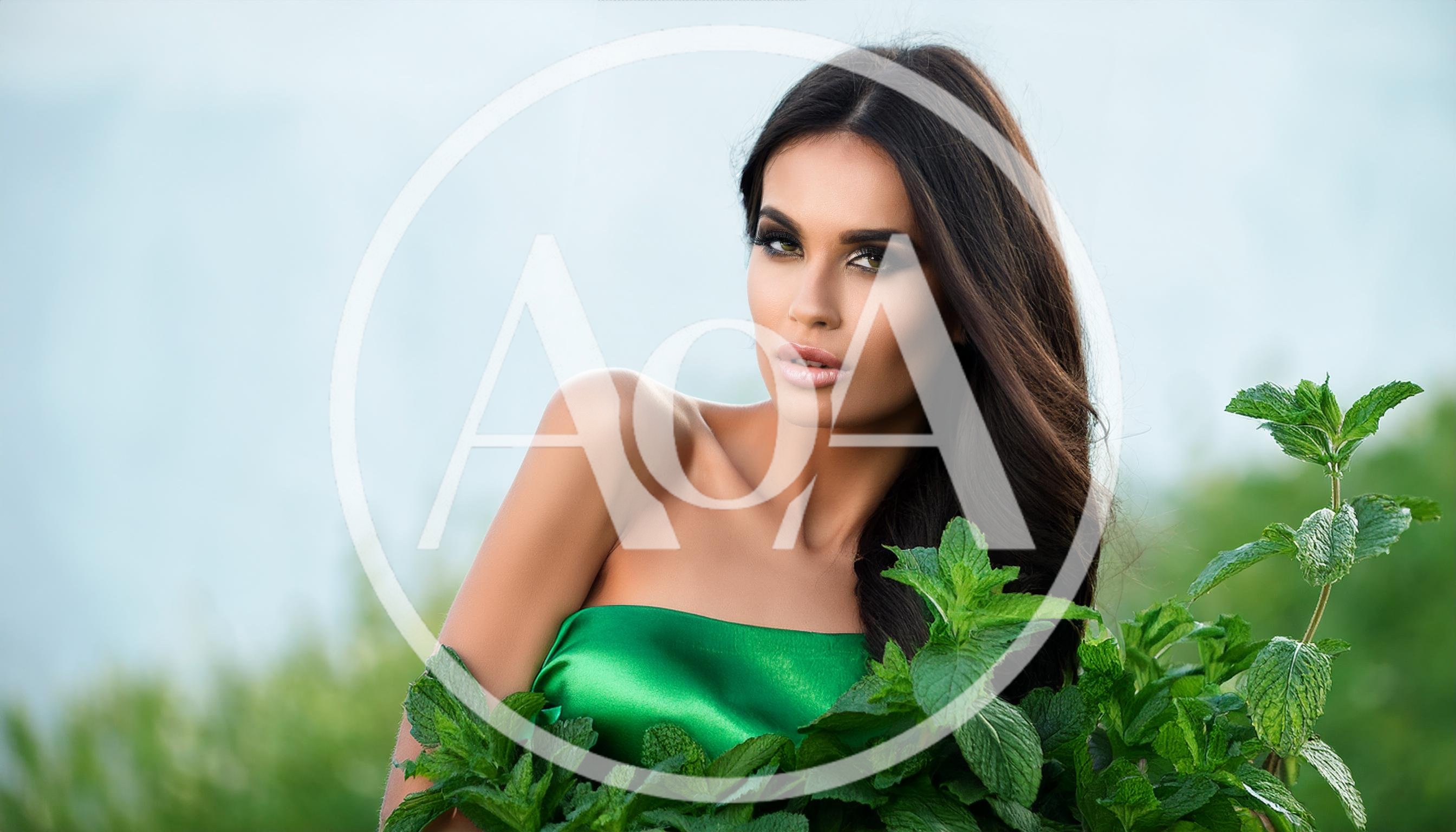 Beautiful Woman Posing With Fresh Green Mint Leaves