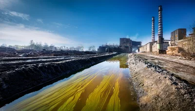 Polluted Industrial Canal Near Abandoned Factory Complex