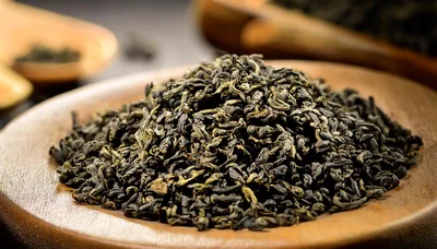 Dried Green Tea Leaves On A Wooden Spoon