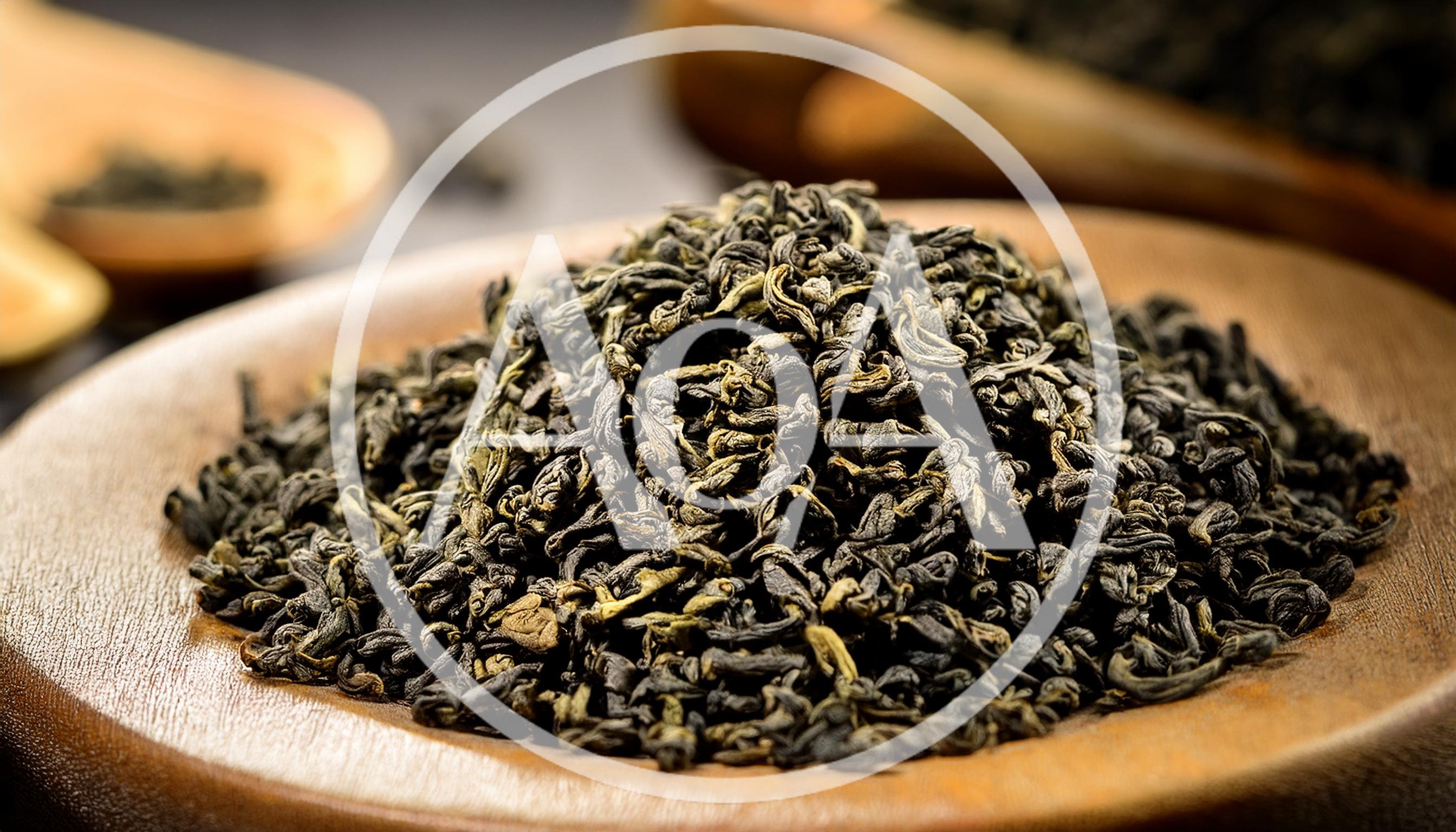 Dried Green Tea Leaves On A Wooden Spoon