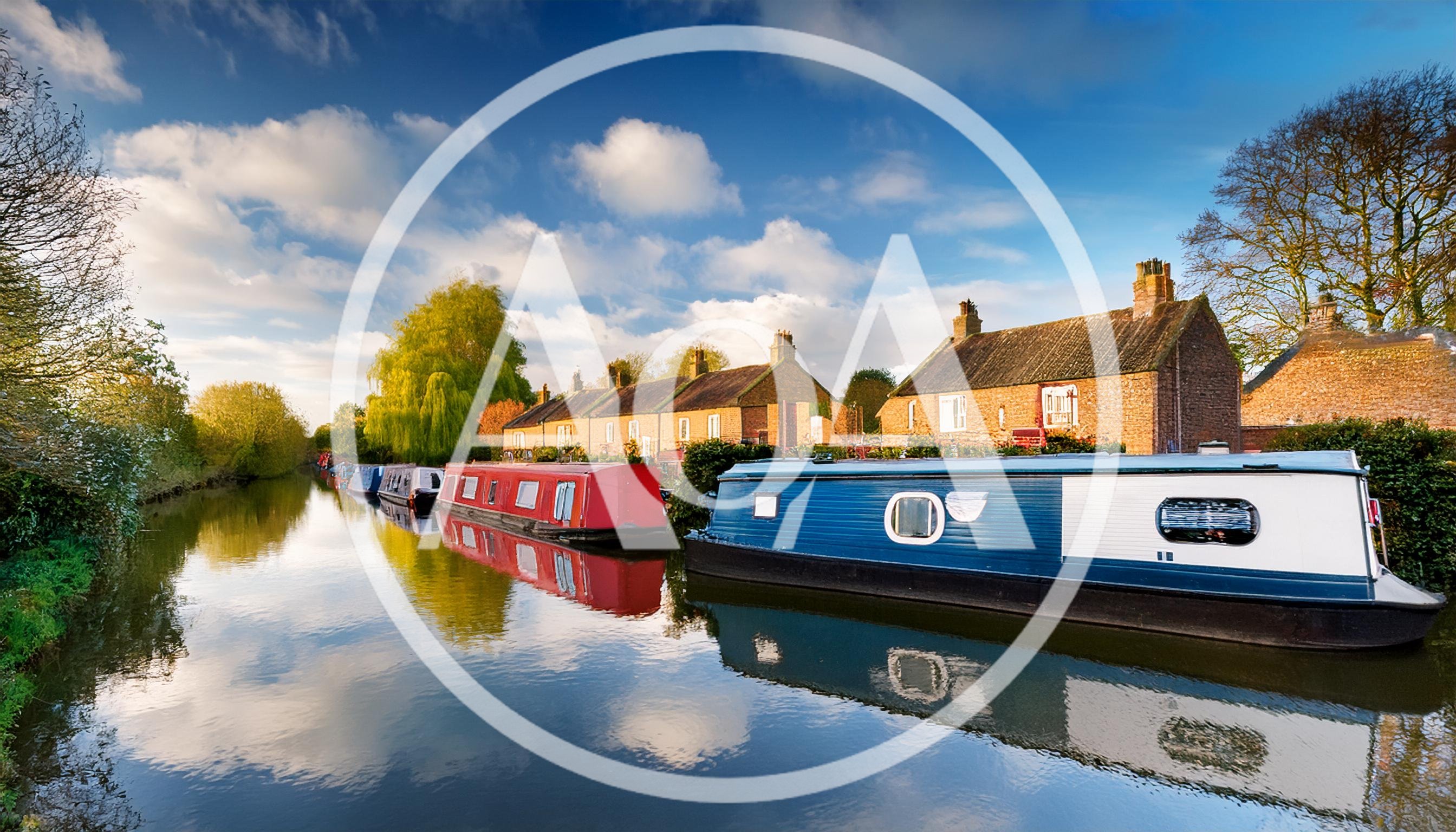 Narrowboats Moored Along A Canal In The English Countryside