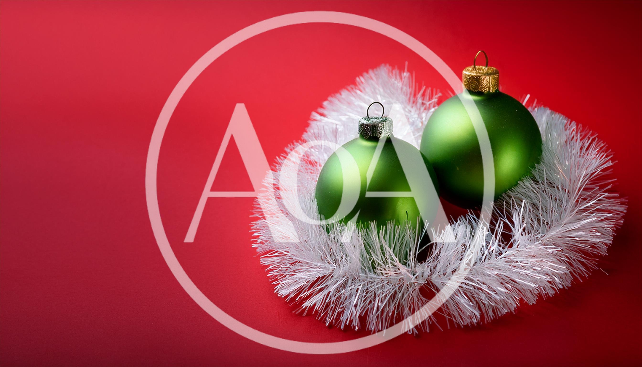 Two Green Christmas Ornaments With White Tinsel