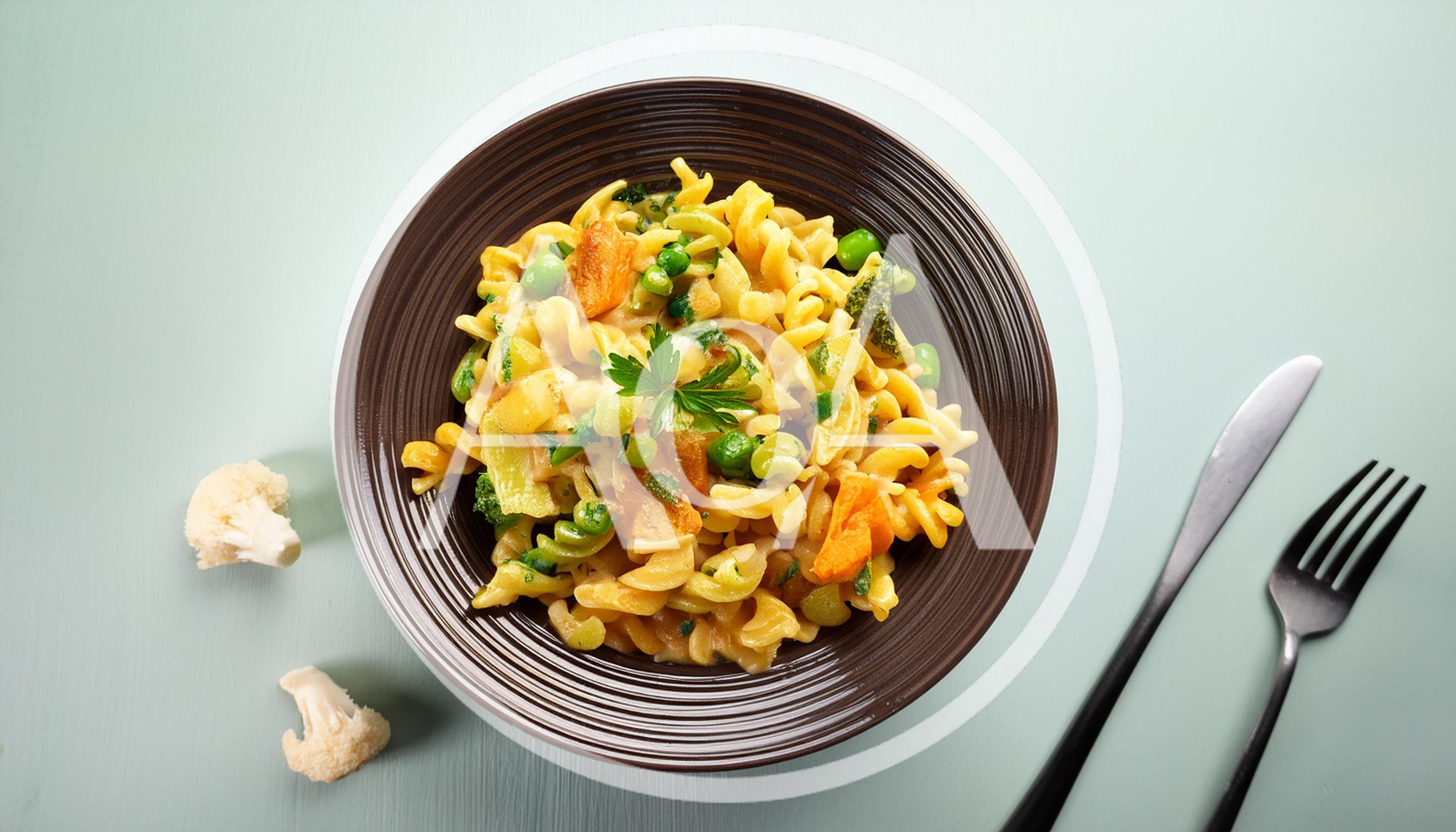 Bowl Of Creamy Vegetable Pasta With Cutlery