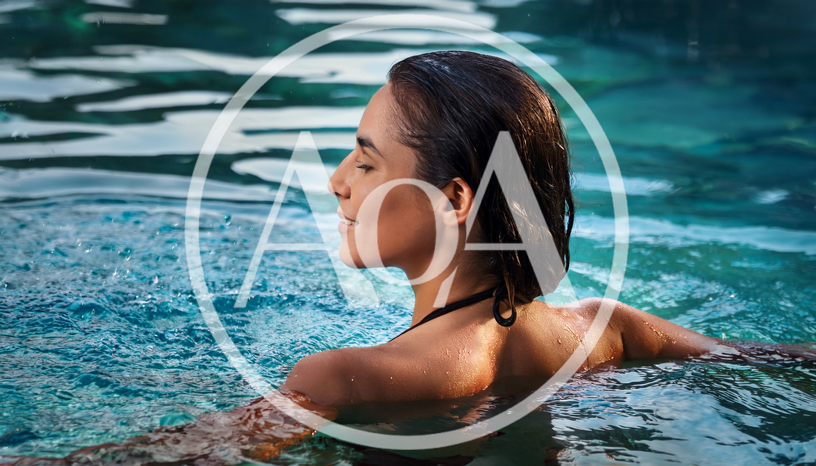 Woman Relaxing In A Swimming Pool