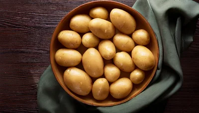 Fresh Raw Potatoes In A Wooden Bowl