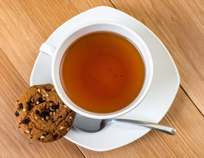 Cup Of Tea With A Cookie On A Wooden Table