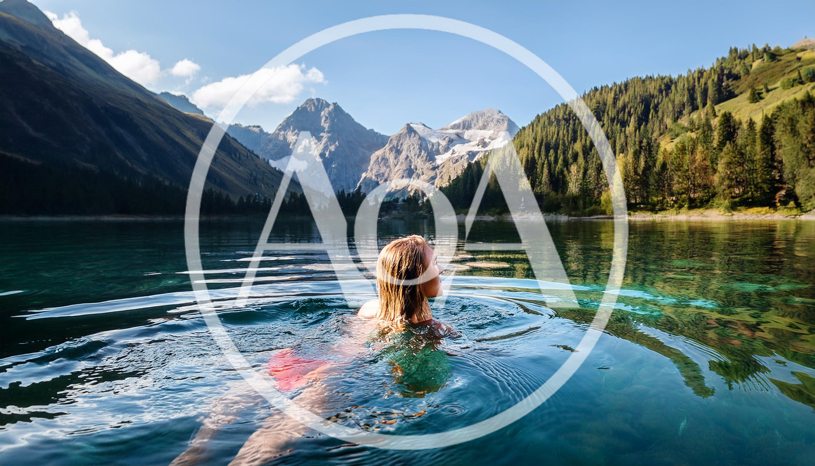Woman Swimming In A Crystal Clear Alpine Lake