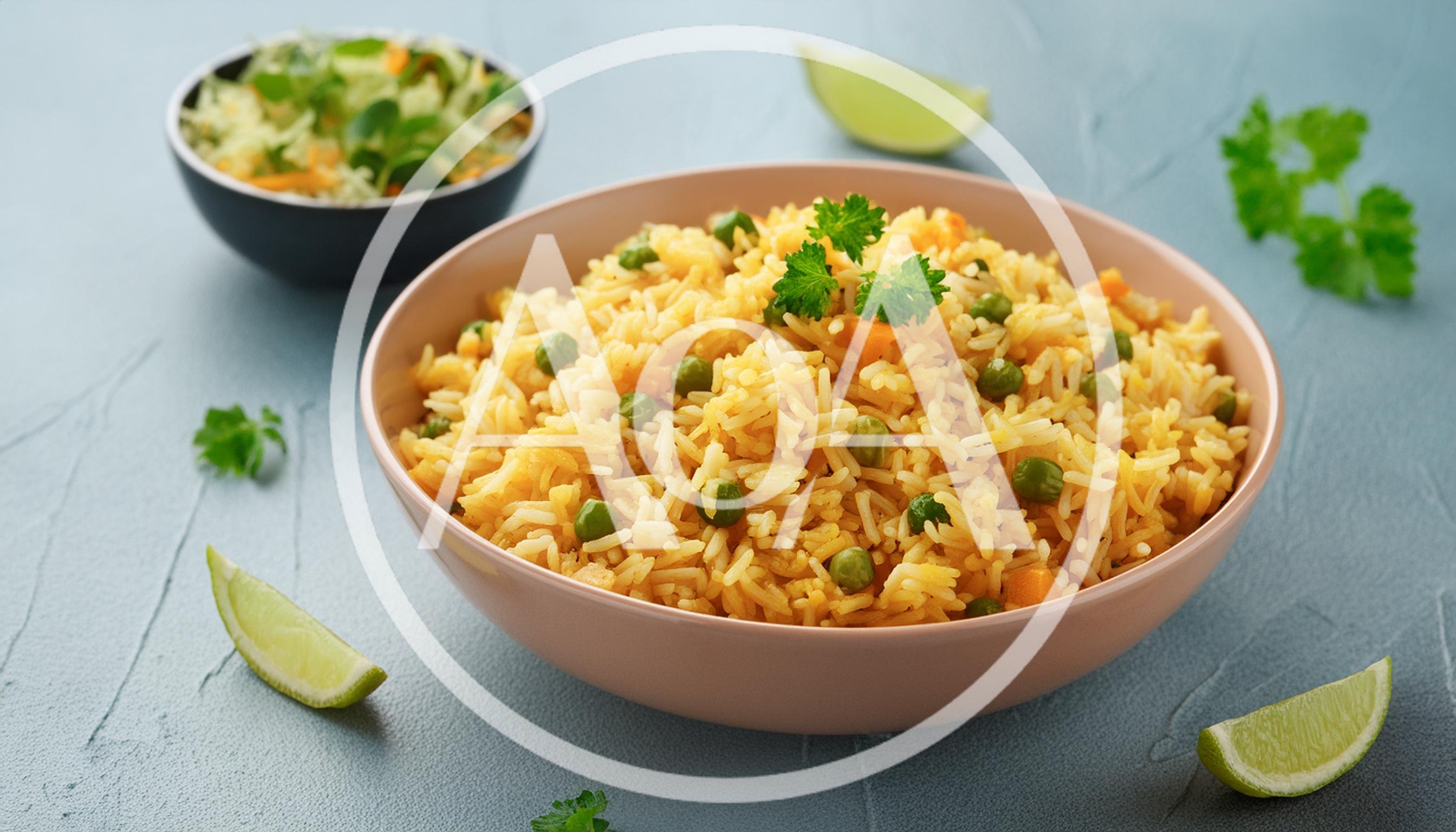 Bowl Of Vegetable Fried Rice With Lime Wedges