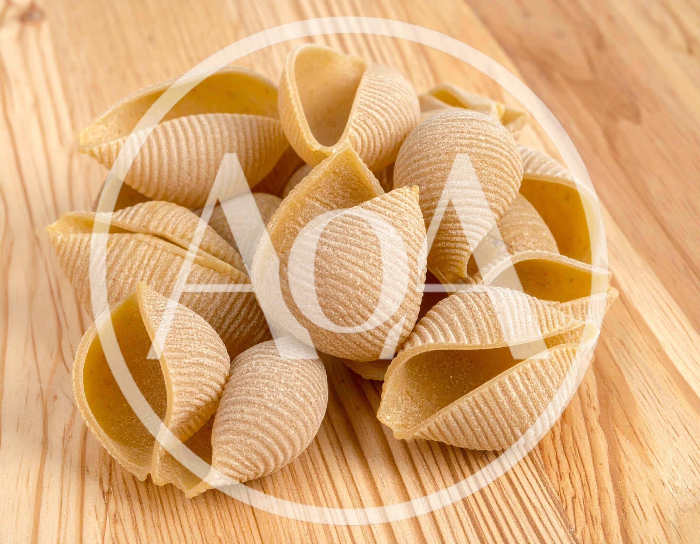 Raw Conchiglioni Pasta Shells on Wooden Surface