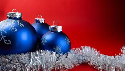 Blue Christmas Ornaments With Silver Tinsel On Red Background