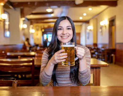 Young Woman Holding A Beer Mug In A Pub