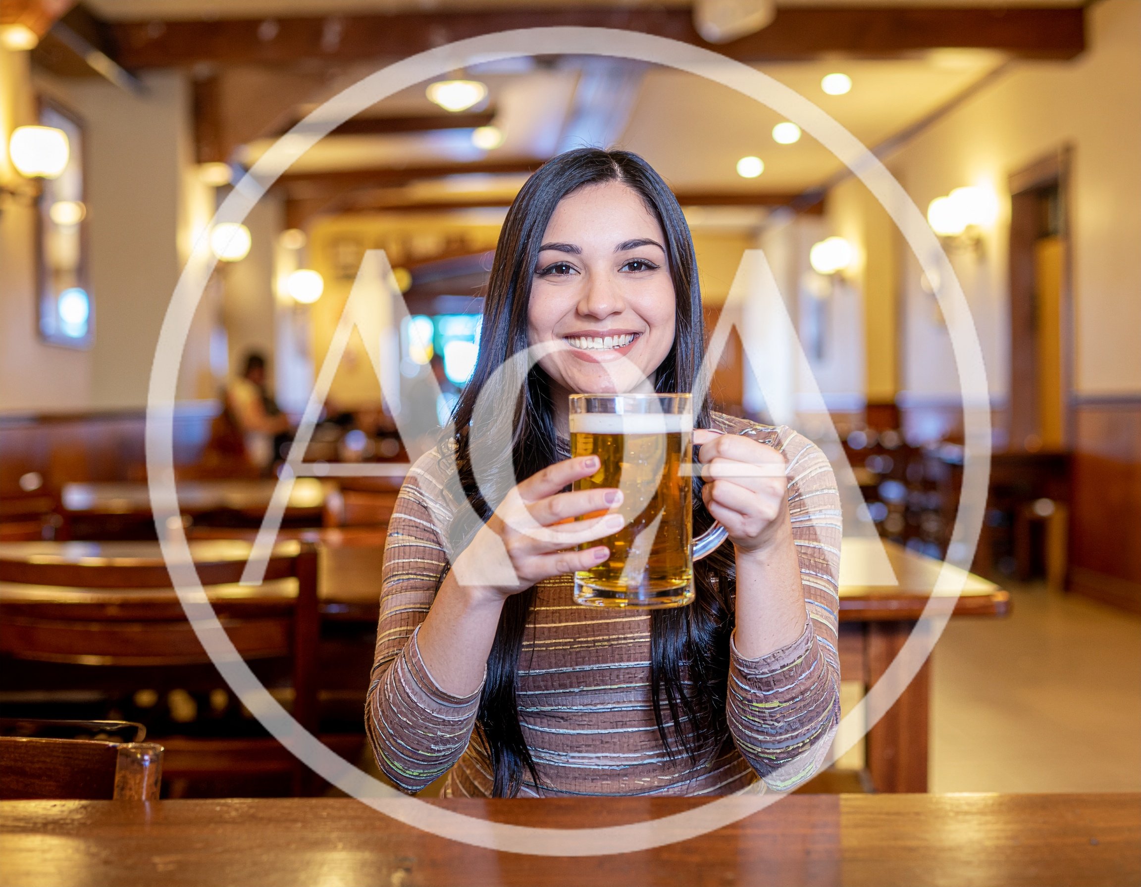 Young Woman Holding A Beer Mug In A Pub