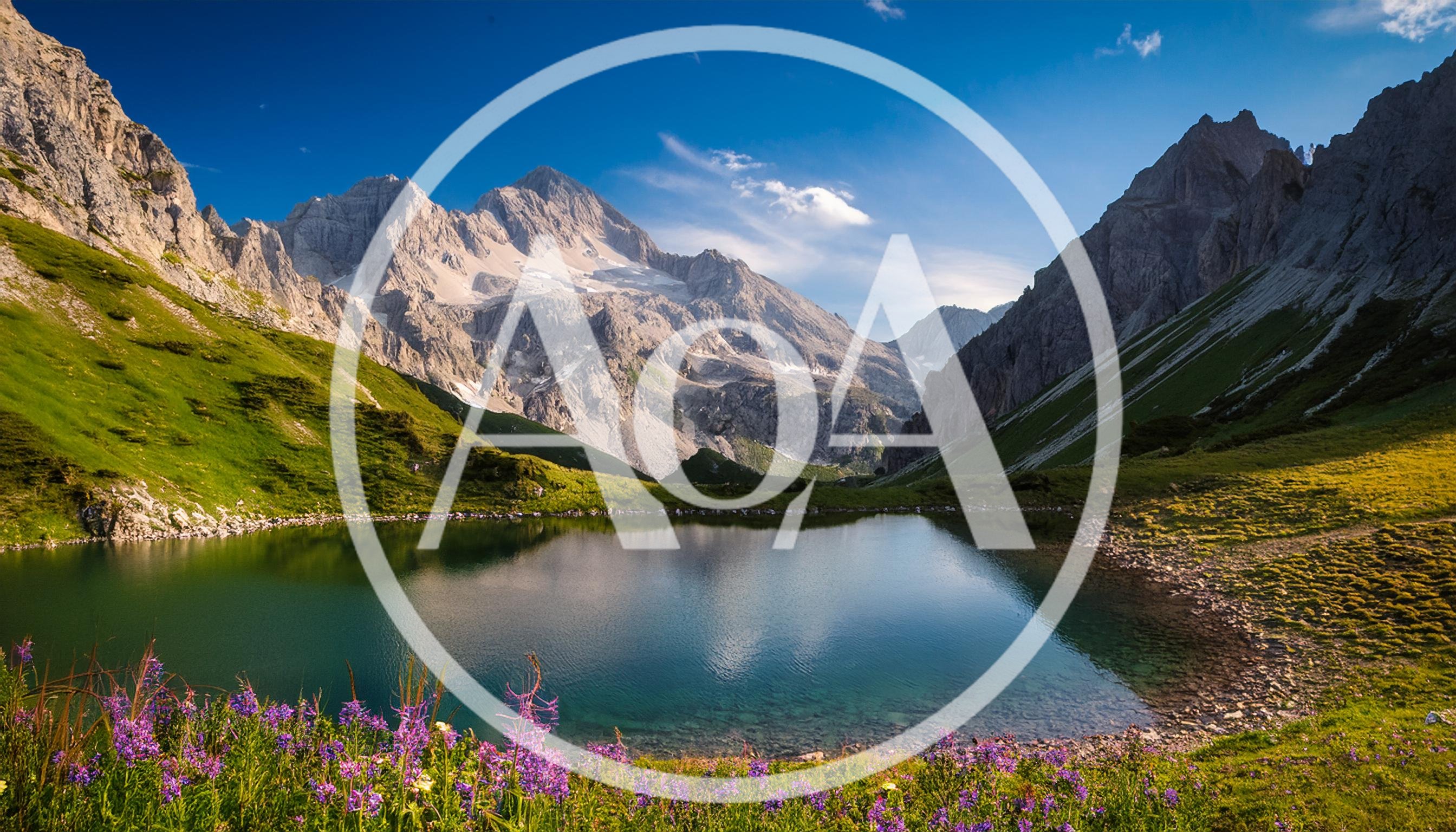 Alpine Lake Surrounded By Jagged Mountain Peaks