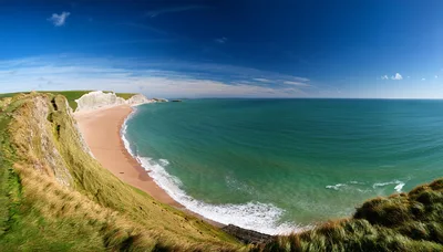 Panoramic View Of White Chalk Cliffs And Sandy Beach