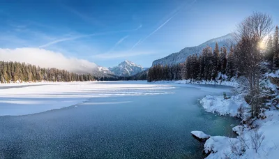 Winter Landscape With Frozen Lake And Snowy Mountains
