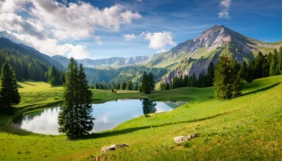 Alpine Lake Surrounded By Lush Green Meadows And Mountains