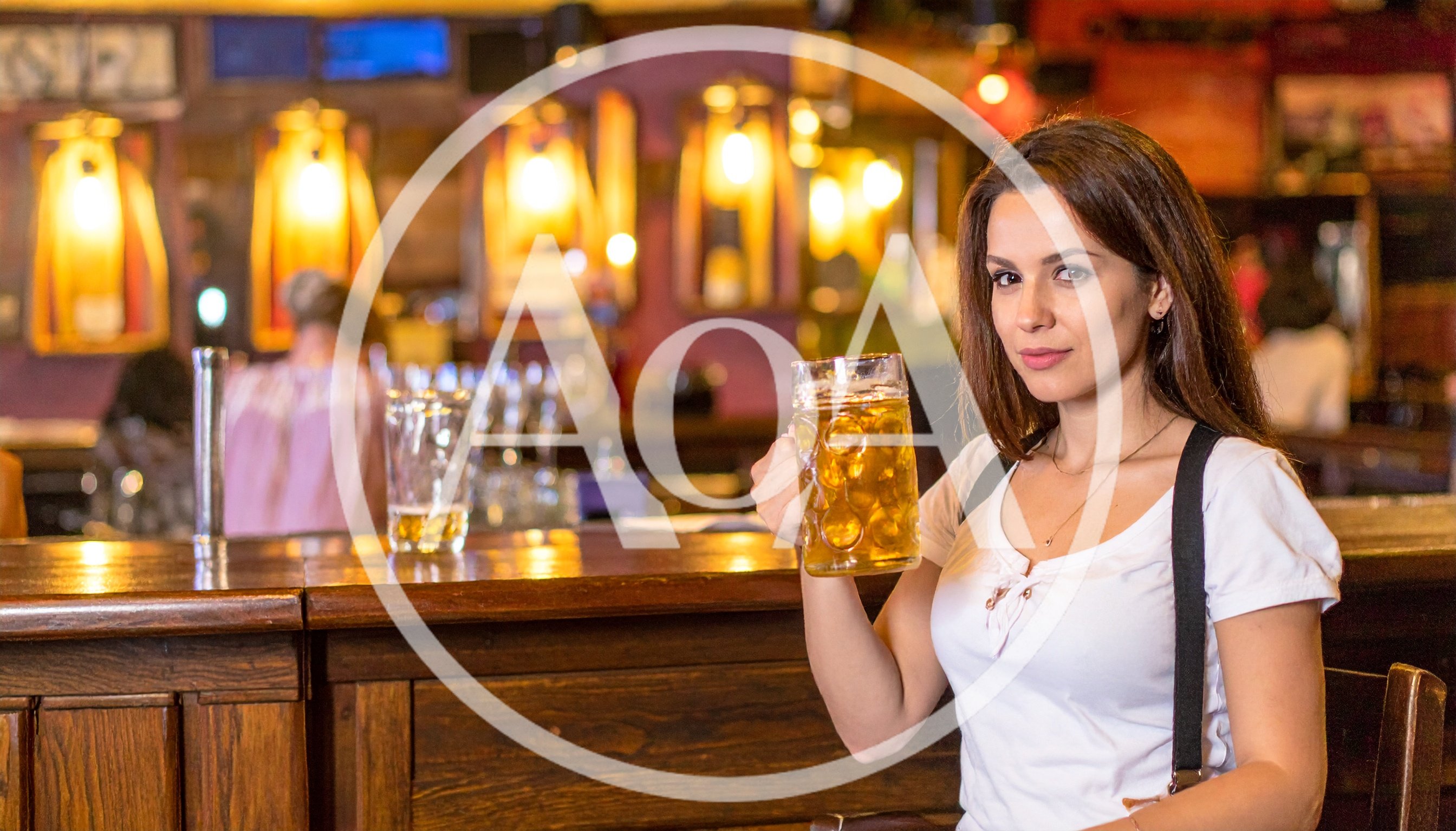 Young Woman Holding A Beer Mug In A Pub