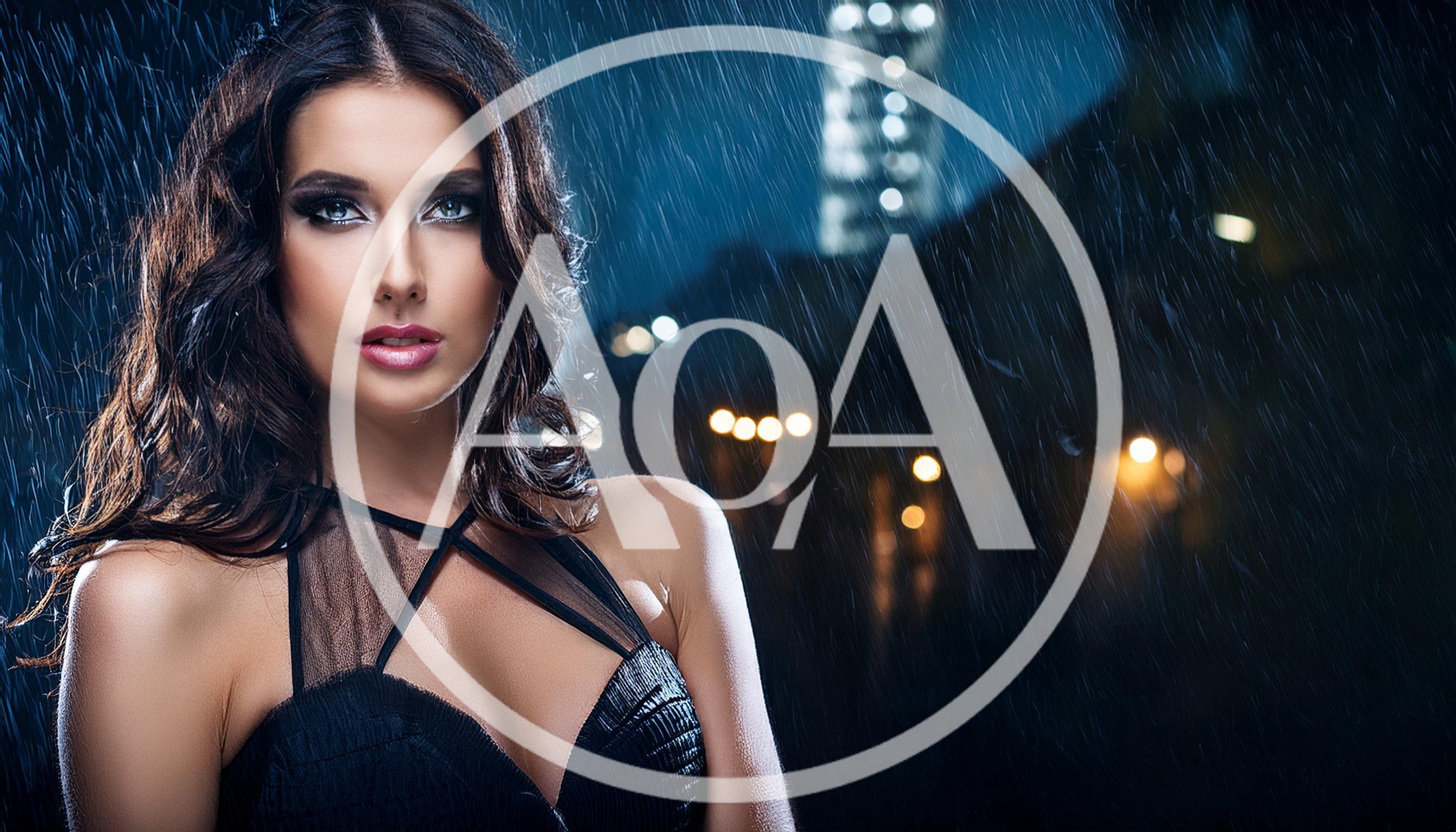Beautiful Woman Posing In The Rain At Night