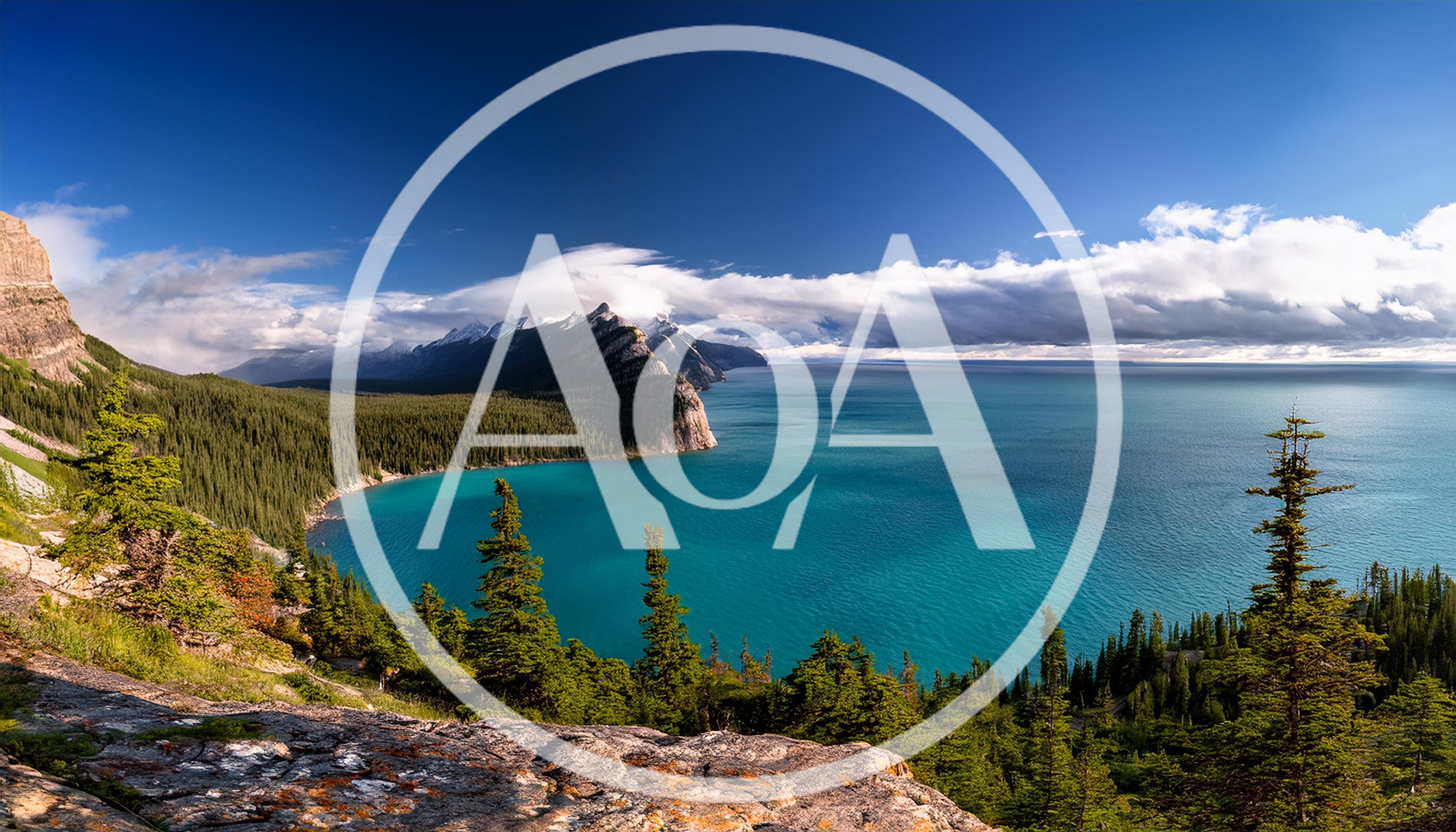 Panoramic View Of Turquoise Lake And Mountain Range