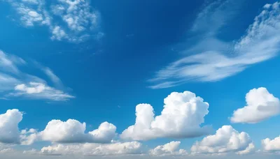 Fluffy White Cumulus Clouds In A Bright Blue Sky