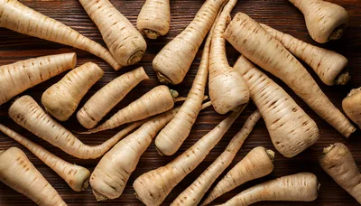 Fresh Raw Parsnips Arranged On Dark Wooden Background
