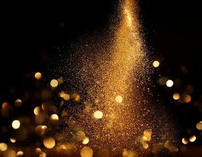 Golden Glitter Particles Falling Against Black Background