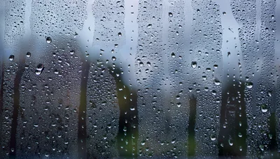 Raindrops Running Down A Glass Window Pane