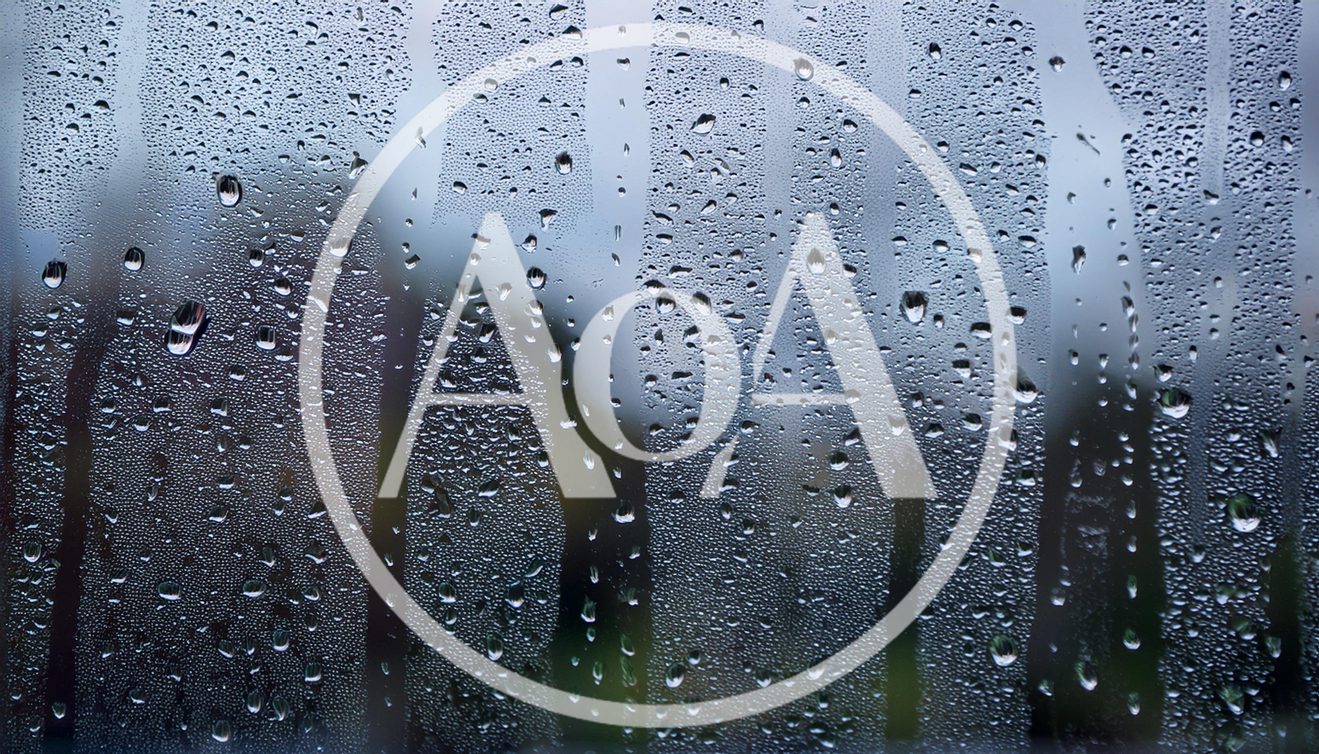 Raindrops Running Down A Glass Window Pane