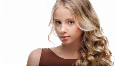 Portrait Of A Young Blonde Girl With Wavy Hair