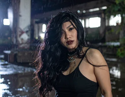 Gothic Woman Standing In Rain At Abandoned Warehouse